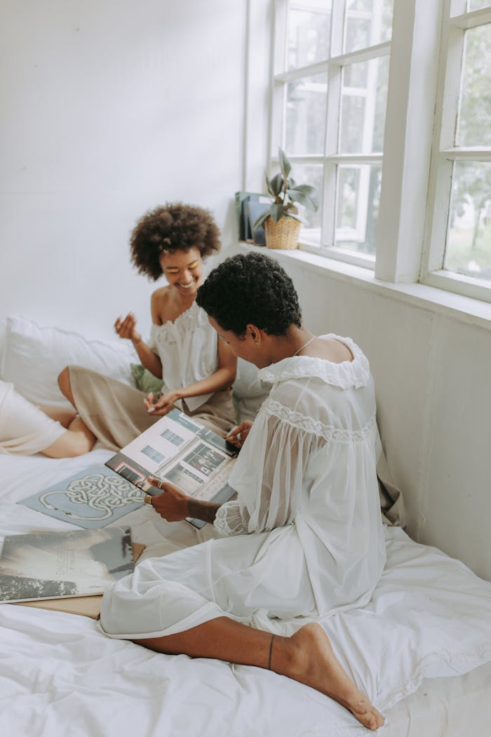 Two women relaxing indoors, sharing music and spending quality time together.